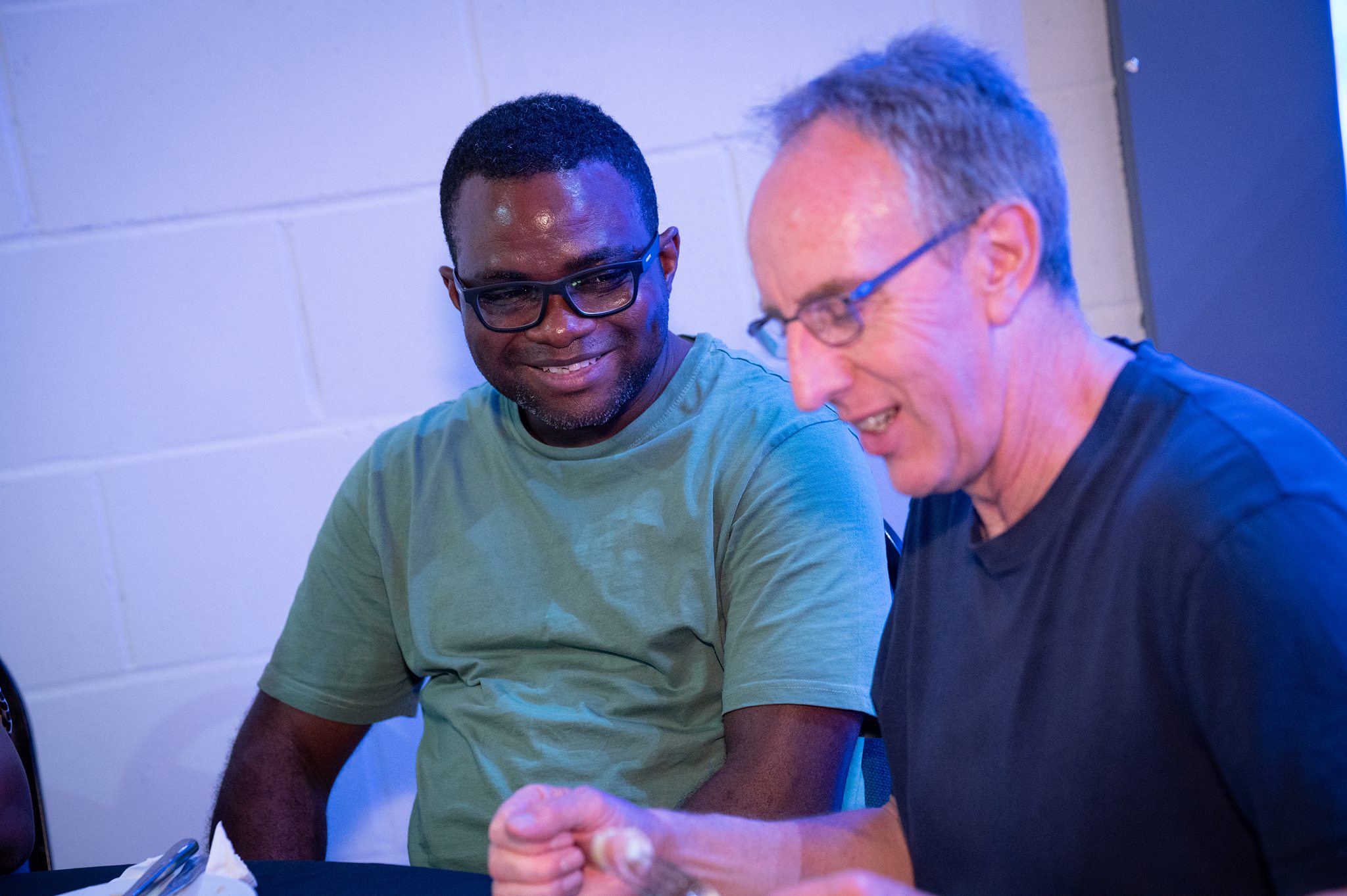 Two men smiling together at a Beacon mens group gathering