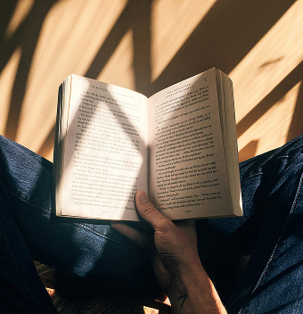 “Person reading a Bible in natural light at Beacon Church in Bury St Edmunds Suffolk”