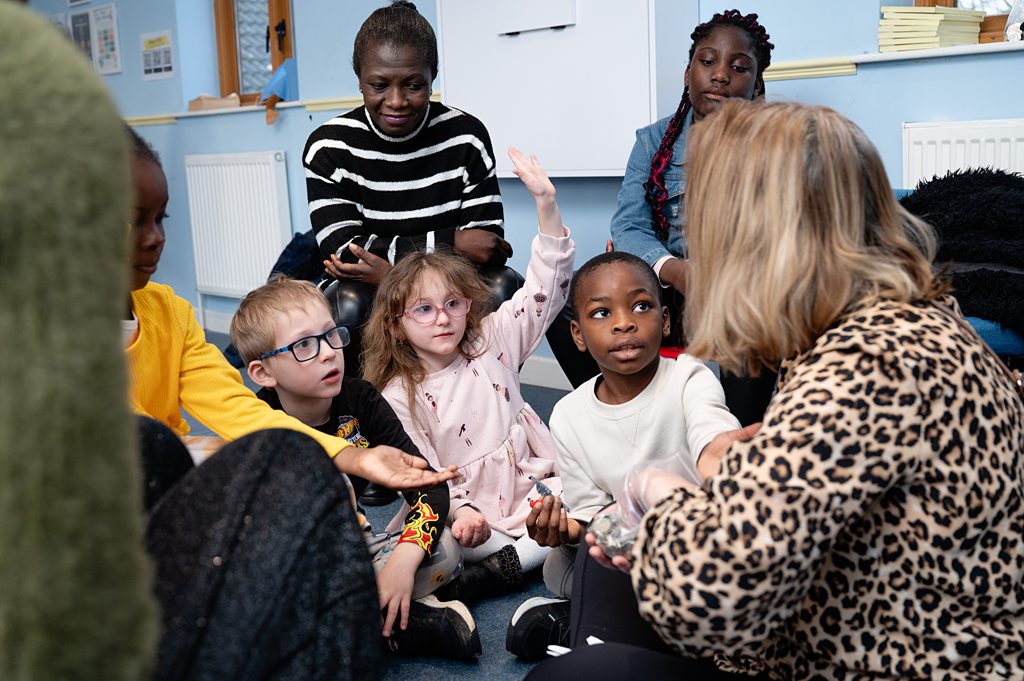 group of kids listening and being taught by Beacon carers