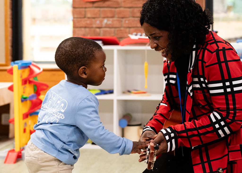 Church volunteer interacting with a young child in a children’s ministry setting in Bury St Edmunds, Suffolk
