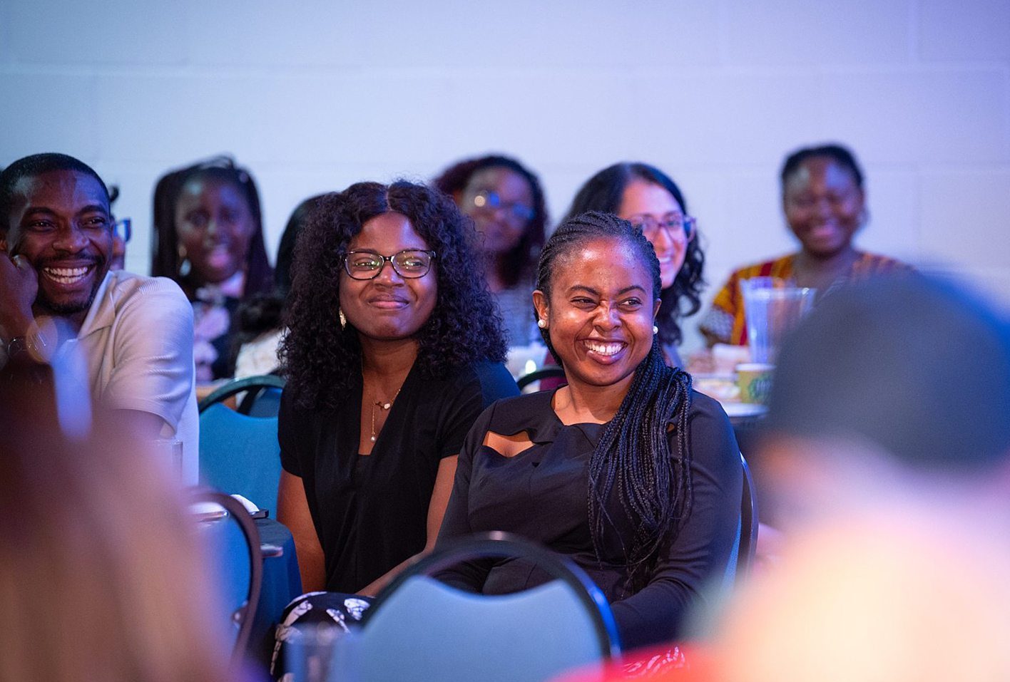 People smiling during a church community event in Bury St Edmunds, Suffolk.