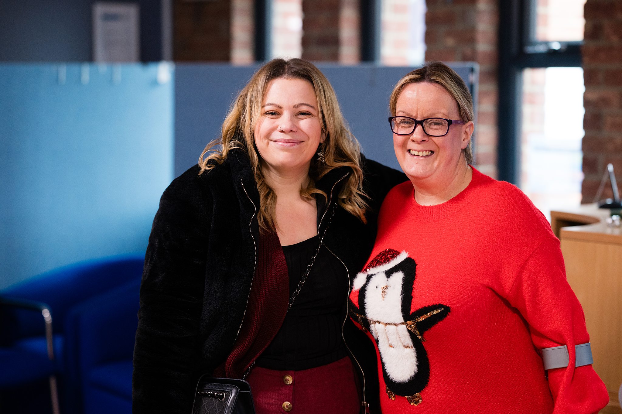 Two women smiling together and building friendship at a church in Bury St Edmunds, Suffolk