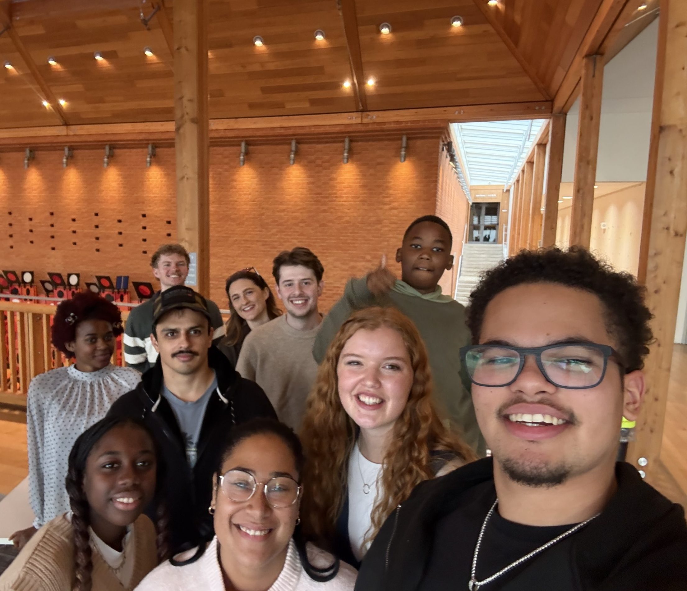 Diverse group of young adults smiling together at a church gathering in Bury St Edmunds, Suffolk