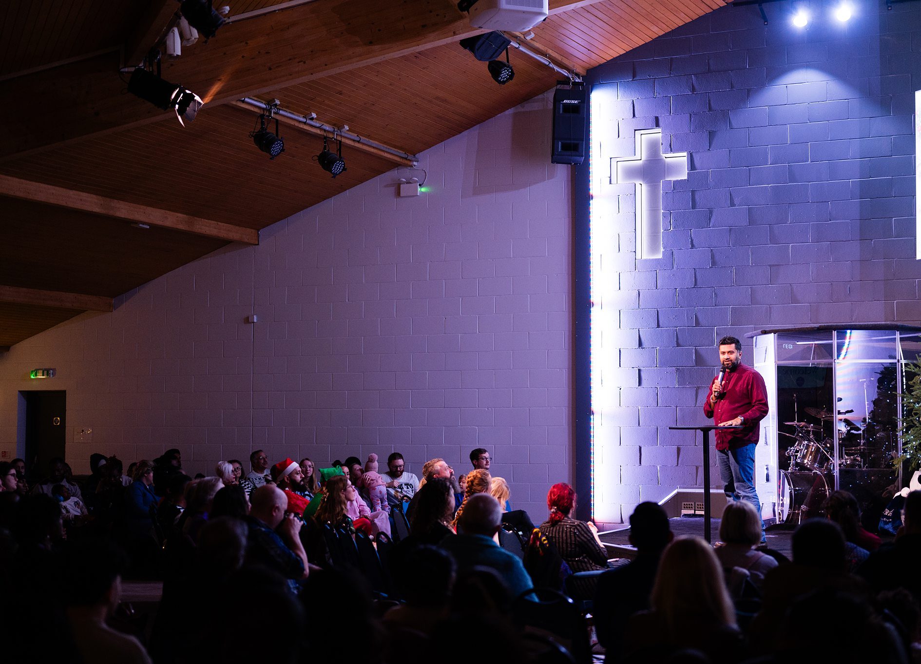 Church service with speaker on stage and congregation gathered in Bury St Edmunds, Suffolk