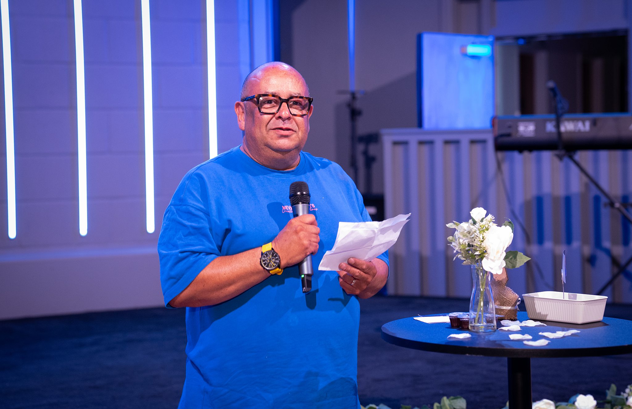 A man speaking with a microphone at a church event in Bury St Edmunds, Suffolk.