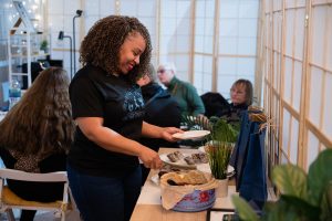Woman preparing refreshments at a church welcome table in Bury St Edmunds, Suffolk