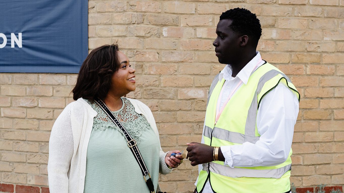 Church welcome team member greeting a visitor outside a church in Bury St Edmunds, Suffolk