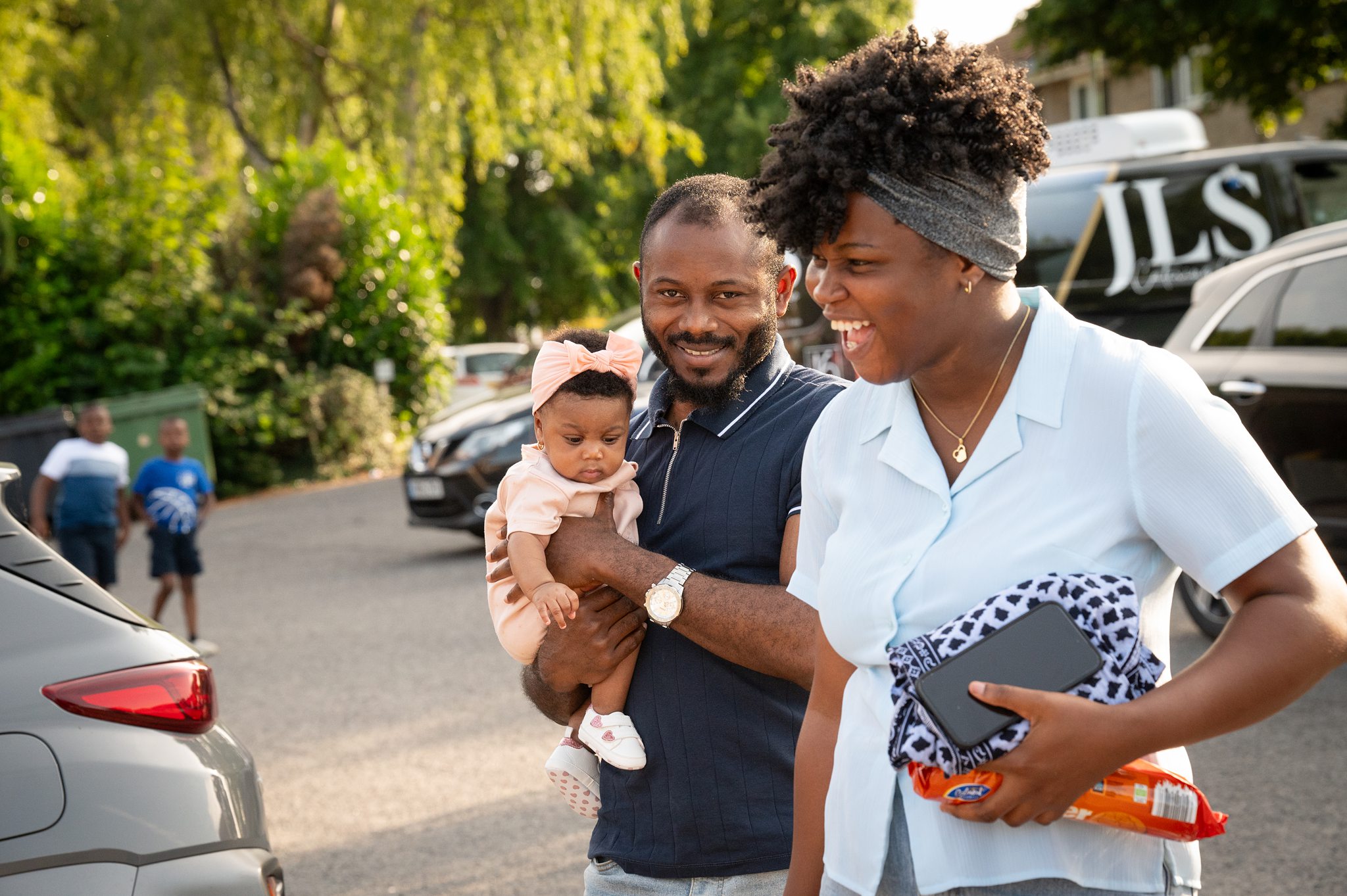 Family arriving and connecting outside a church in Bury St Edmunds, Suffolk