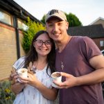 “Couple smiling and enjoying refreshments together at a church gathering in Bury St Edmunds, Suffolk”