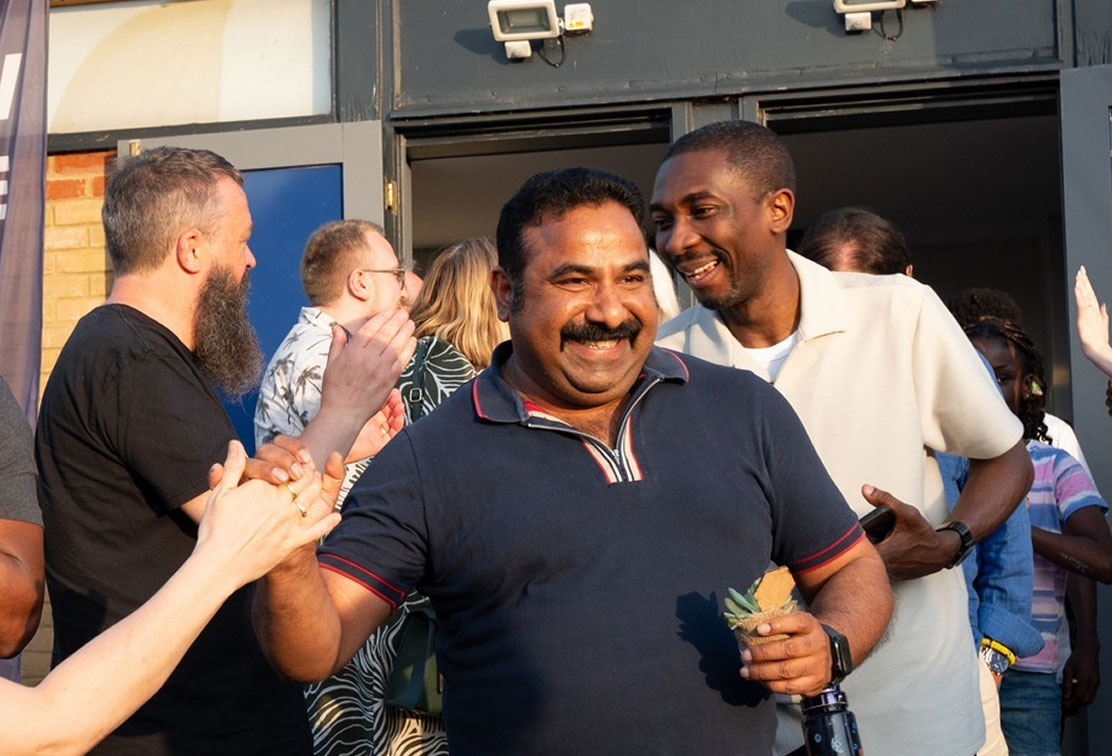 “People greeting each other with smiles and high fives outside a church in Bury St Edmunds, Suffolk”