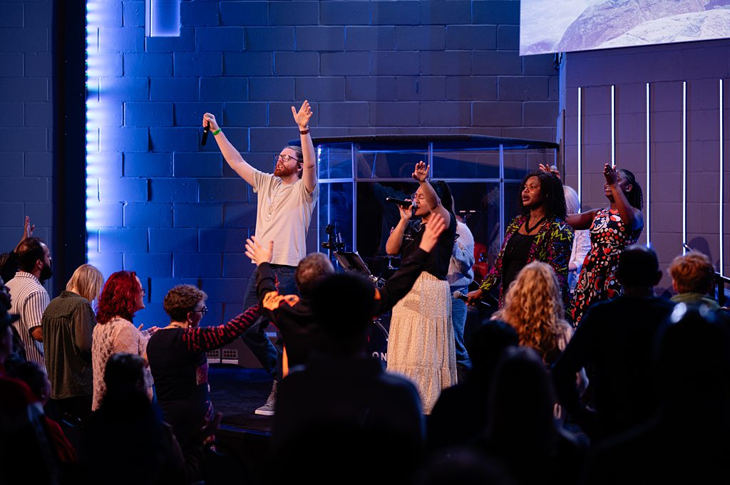 “Worship band leading people with raised hands during a church worship night in Bury St Edmunds, Suffolk”