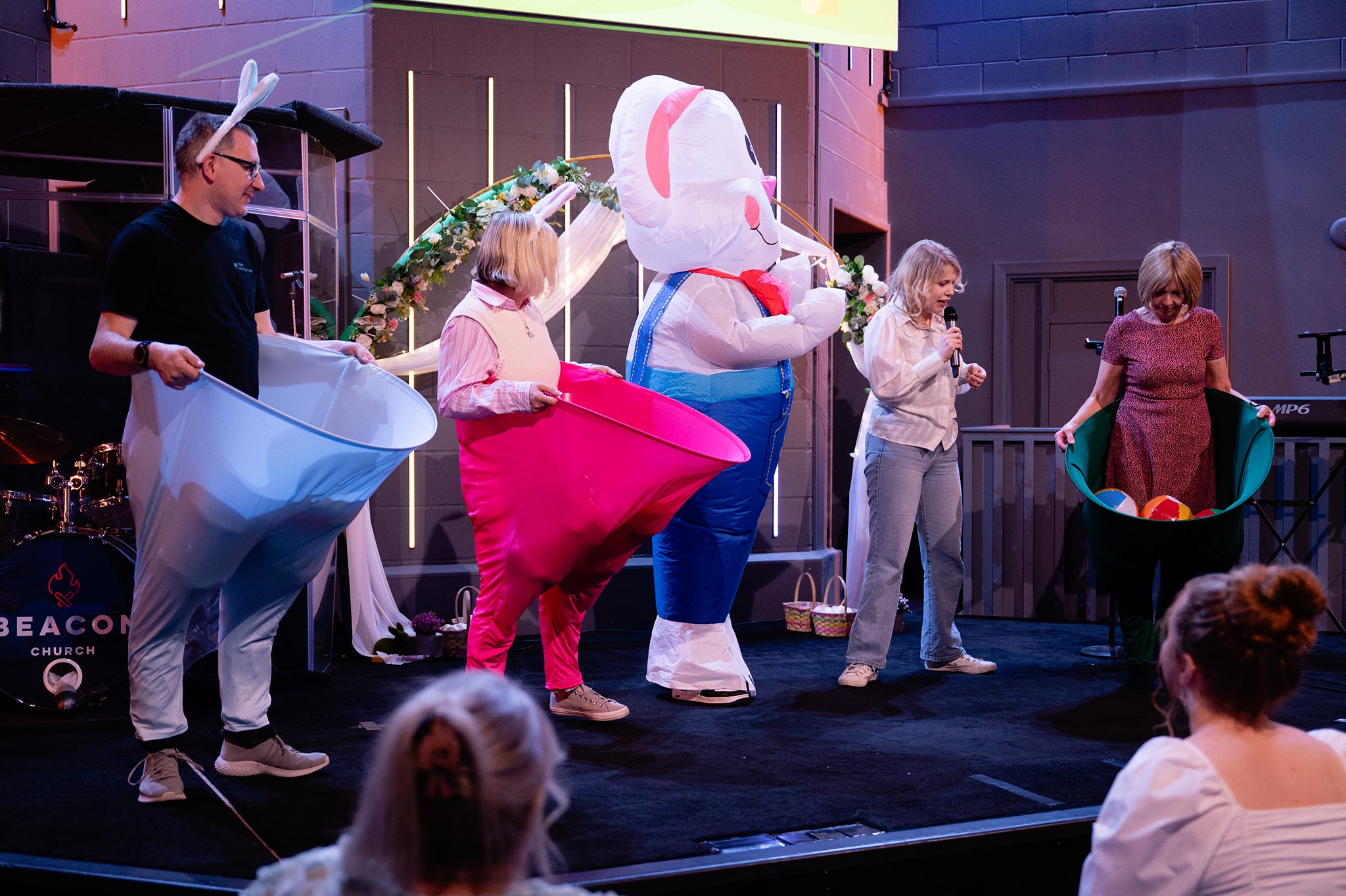 Church members taking part in a fun Easter Sunday stage activity at Beacon Church in Bury St Edmunds, Suffolk, during a family-friendly Easter celebration service.