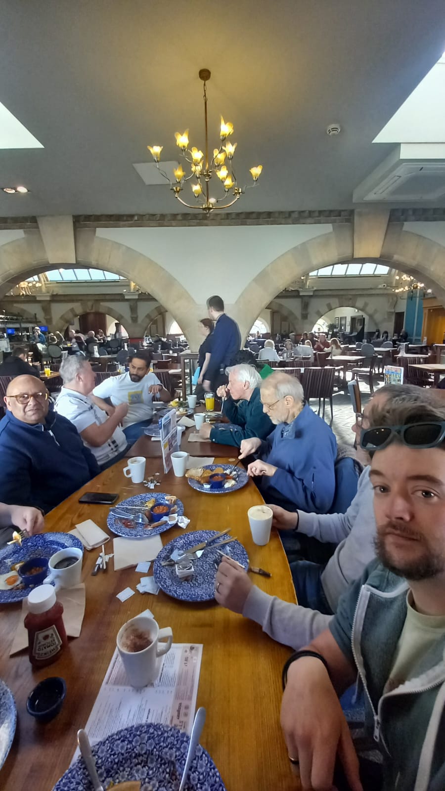Men from Beacon Church in Bury St Edmunds, Suffolk gathering for breakfast, conversation, and community at a local fellowship event, building friendships and faith together.