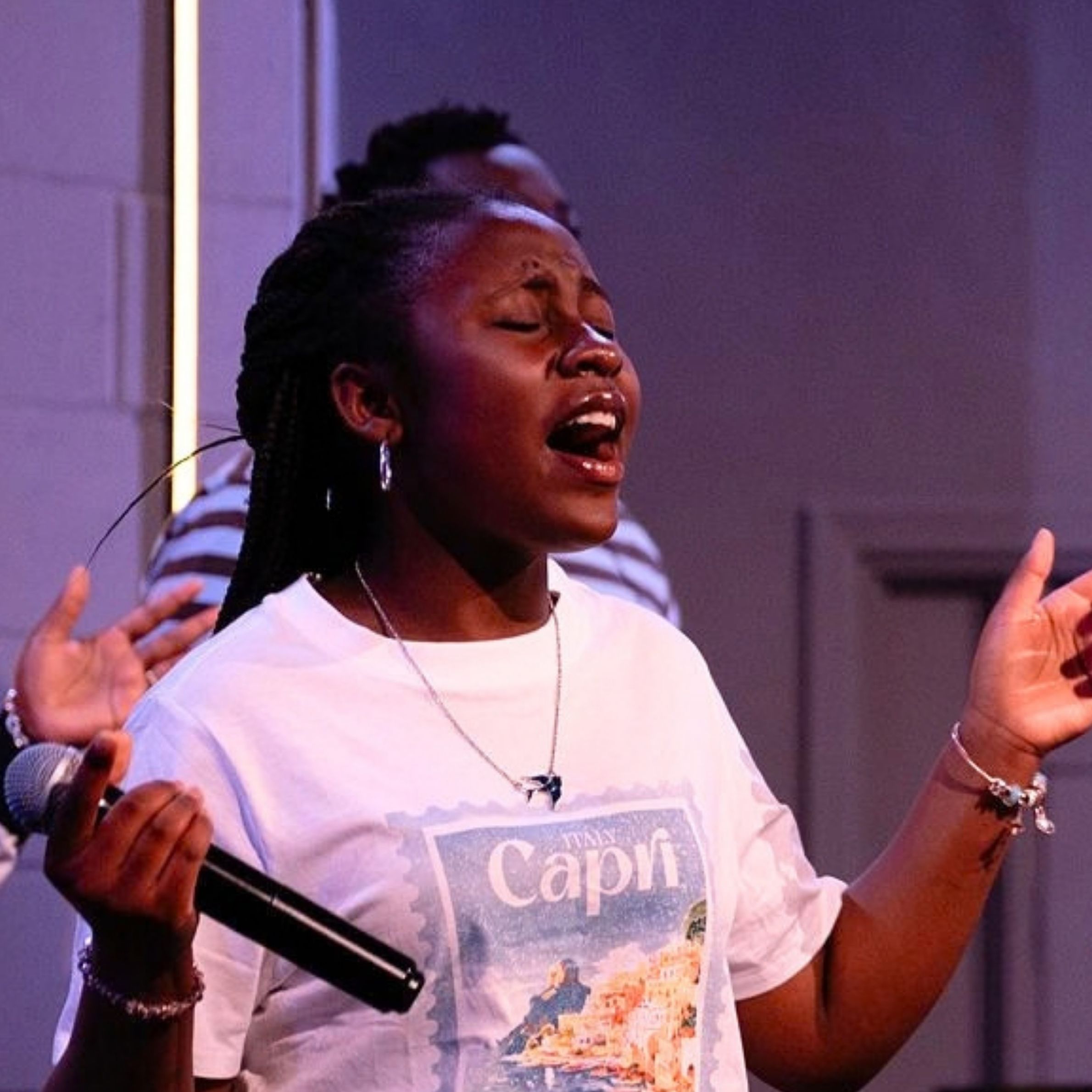 Worship leader singing during a church service at Beacon Church in Bury St Edmunds, Suffolk.