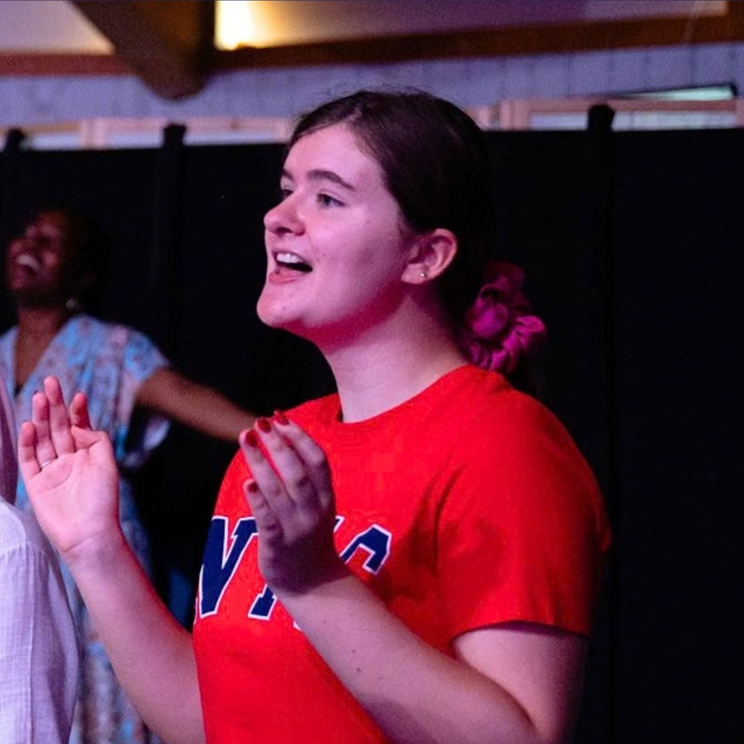 Young person worshipping during a church service at Beacon Church in Bury St Edmunds, Suffolk.